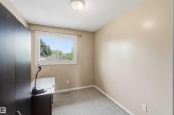 Neutral painted walls complement the textured carpet flooring - 