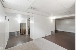 Versatile lower level featuring white walls, drop ceiling, and a combination of carpet and hard-surface flooring - 