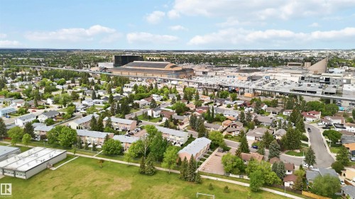 Expansive aerial showcasing a residential area with varied housing styles, mature trees, and a green space - 17325 85 Avenue Nw, Edmonton, AB 