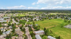 Expansive aerial landscape featuring a residential neighborhood with detached homes and townhomes - 