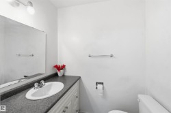Vanity with an integrated white sink and dark grey countertop - 