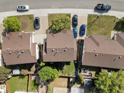 Aerial perspective showcasing residential properties with brown shingle roofs - 