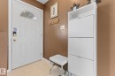 White paneled entry door with an arched transom window and polished brass hardware - 17132 103 Street, Edmonton, AB 