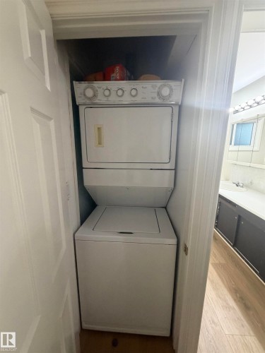 Dedicated laundry closet featuring a stackable washer and dryer unit - 9640 74 Avenue, Edmonton, AB 
