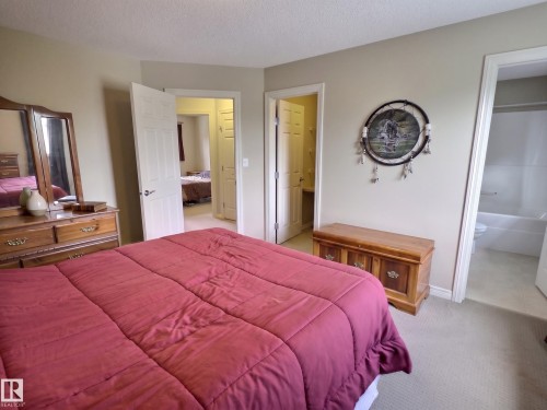 Carpeted bedroom featuring light neutral wall paint and white trim - 126 Calvert Wynd, Fort Saskatchewan, AB 