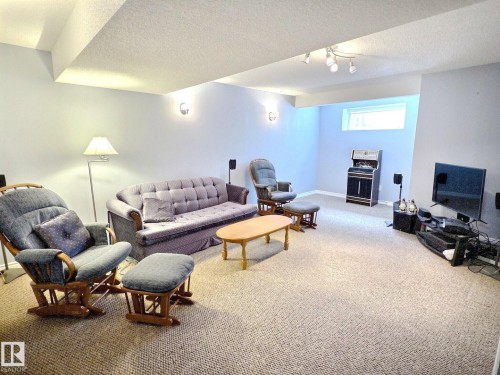 Finished room featuring light blue walls and textured carpeting - 126 Calvert Wynd, Fort Saskatchewan, AB 