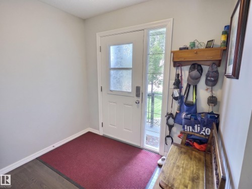 Entryway featuring a white paneled door with frosted glass and clear sidelight - 126 Calvert Wynd, Fort Saskatchewan, AB 