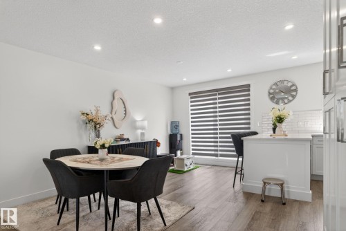 Open-concept living area featuring recessed lighting, wood-finish flooring, and white walls - 16 9250 156 Avenue, Edmonton, AB 