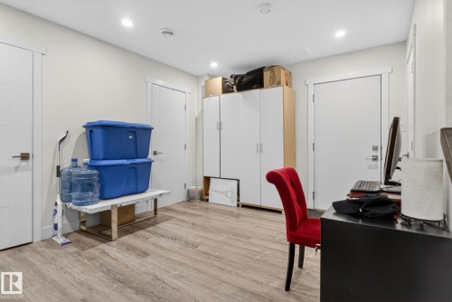 Spacious interior featuring wood-finish flooring, recessed lighting, and crisp white trim - 16 9250 156 Avenue, Edmonton, AB 