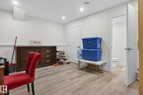 Room featuring wood-finish flooring, recessed lighting, and a white interior door with contemporary hardware - 16 9250 156 Avenue, Edmonton, AB 