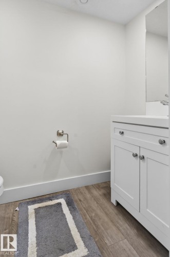 White shaker-style vanity with a white countertop and rectangular sink, featuring brushed nickel hardware - 16 9250 156 Avenue, Edmonton, AB 