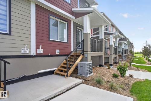 Modern multi-unit dwelling with a combination of lap siding and board and batten siding - 16 9250 156 Avenue, Edmonton, AB 