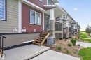 Modern multi-unit dwelling with a combination of lap siding and board and batten siding - 16 9250 156 Avenue, Edmonton, AB 