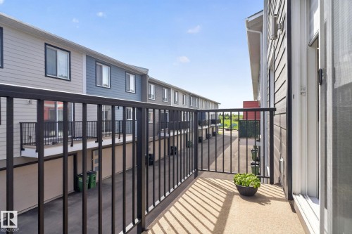 Exterior balcony featuring a black metal railing and concrete flooring - 16 9250 156 Avenue, Edmonton, AB 