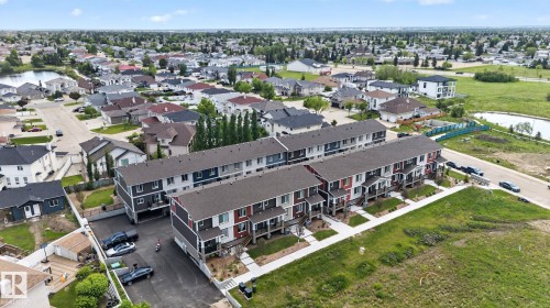 Modern townhome complex featuring multi-level units with private balconies, contemporary siding, and individual entrances - 16 9250 156 Avenue, Edmonton, AB 