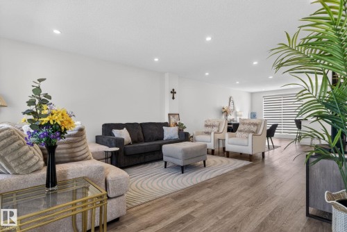 Open-concept living area featuring recessed lighting, wood-finish flooring, and light-toned walls - 16 9250 156 Avenue, Edmonton, AB 