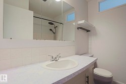 Bathroom vanity featuring a built-in sink and chrome faucet - 