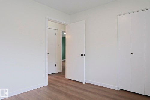 Interior room featuring light wood-finish flooring and white walls - 10 Murray Crescent, St. Albert, AB 