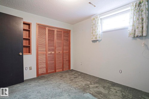 Interior room featuring light gray walls and green patterned carpeting - 10 Murray Crescent, St. Albert, AB 