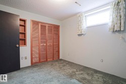 Interior room featuring light gray walls and green patterned carpeting - 