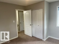 Neutral-toned walls complement plush carpeting - 