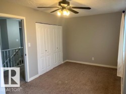 Bedroom featuring neutral wall paint and brown carpet - 
