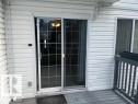 Sliding glass door with grid panes providing access to an exterior deck - 16-1033 Youville Dr. West Nw, Edmonton, AB  - Outdoor With Exterior 