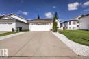 Front exterior featuring an attached two-car garage, concrete driveway, and white siding - 946 Jordan Crescent, Edmonton, AB 