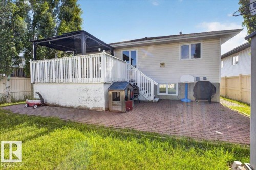 Rear exterior with a spacious elevated deck featuring a black gazebo, white railing, and exterior staircase - 946 Jordan Crescent, Edmonton, AB 