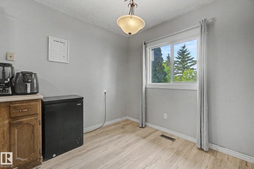 Wood-finish flooring complementing light gray walls - 45 2020 105 Street, Edmonton, AB 
