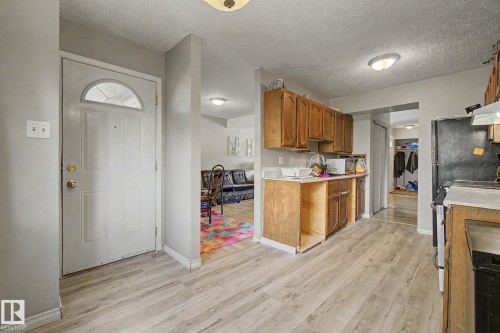 Kitchen featuring wood-finish flooring and wood cabinetry - 45 2020 105 Street, Edmonton, AB 