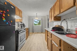 Kitchen featuring wood-finish cabinetry, stainless steel range, and a window with natural light - 