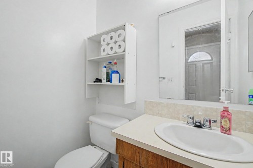 Recessed vanity with an integral sink, chrome faucet, and a stone-finish countertop - 45 2020 105 Street, Edmonton, AB 