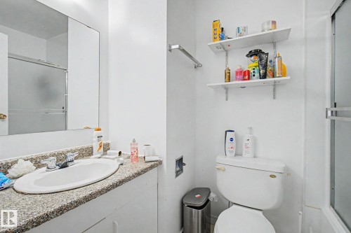 Bathroom featuring a white vanity with a speckled countertop, a built-in sink, and a chrome faucet - 45 2020 105 Street, Edmonton, AB 