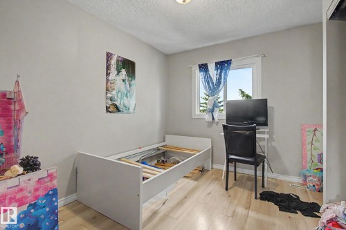 Room featuring wood-finish flooring, a single window, and light-toned wall paint - 45 2020 105 Street, Edmonton, AB 