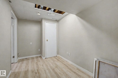 Room featuring wood-finish flooring, light gray painted walls, and white baseboards - 45 2020 105 Street, Edmonton, AB 