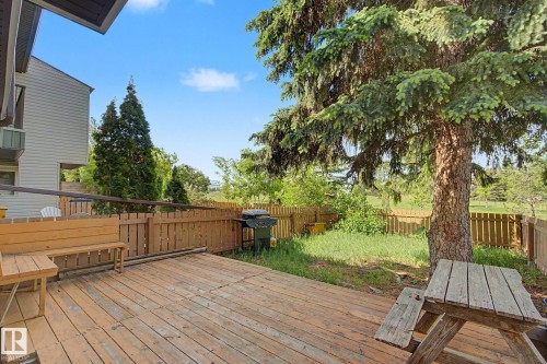 Spacious wood-finish deck with a built-in bench, surrounded by a wood privacy fence - 45 2020 105 Street, Edmonton, AB 