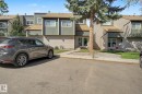 Townhome exterior featuring horizontal siding, vertical paneling, and a pitched roofline - 45 2020 105 Street, Edmonton, AB 