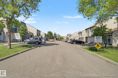 Townhome community featuring multi-level units with light-toned siding and dark trim accents - 45 2020 105 Street, Edmonton, AB 
