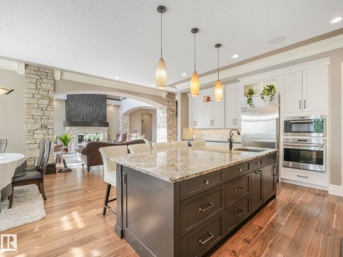 Expansive kitchen island featuring a light-toned countertop and pendant lighting - 2807 Wheaton Drive, Edmonton, AB 