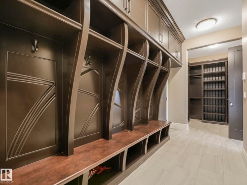 Built-in mudroom cabinetry with decorative paneling and integrated bench seating - 2807 Wheaton Drive, Edmonton, AB 