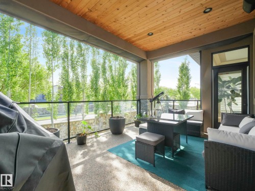 Covered outdoor patio featuring a wood-finish plank ceiling with recessed lighting - 2807 Wheaton Drive, Edmonton, AB 