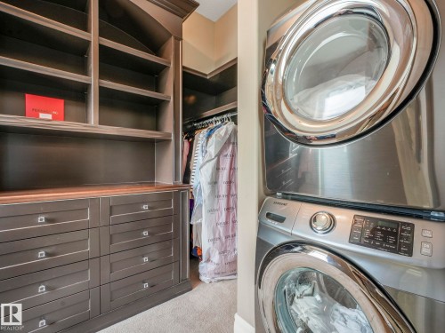 Custom closet system featuring built-in shelving, integrated drawers with square silver pulls, and a wood-finish countertop - 2807 Wheaton Drive, Edmonton, AB 