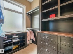 Custom built-in closet system featuring dark wood-finish cabinetry - 