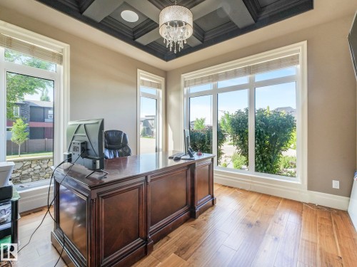 Room featuring wood-finish flooring, a coffered ceiling with recessed lighting, and a crystal chandelier - 2807 Wheaton Drive, Edmonton, AB 