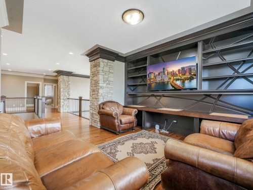 Custom built-in media center with integrated shelving and a dark wood-finish countertop - 2807 Wheaton Drive, Edmonton, AB 