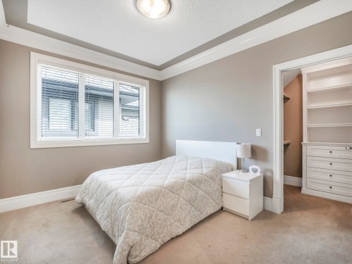 Recessed ceiling with layered trim, neutral wall paint, white window blinds, and plush carpet flooring - 2807 Wheaton Drive, Edmonton, AB 