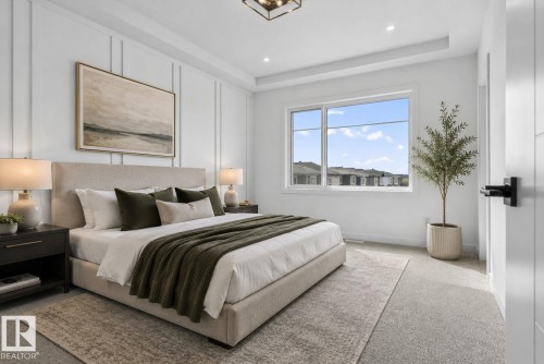 Spacious bedroom featuring white board and batten accent wall, recessed lighting, and a large window - 105 Wyatt Ridge, Fort Saskatchewan, AB 