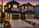 Modern two-story residence featuring a dark gray and light gray exterior with stone accents - 105 Wyatt Ridge, Fort Saskatchewan, AB 