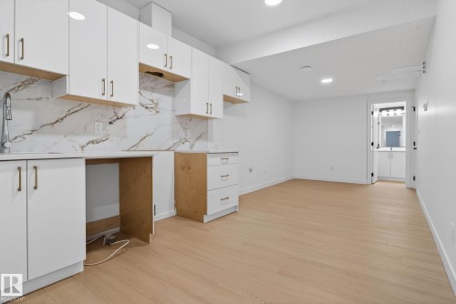 Open-concept space featuring light wood-finish flooring and recessed lighting - 105 Wyatt Ridge, Fort Saskatchewan, AB 